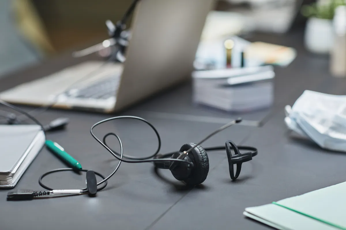 A customer support headset resting on a desk